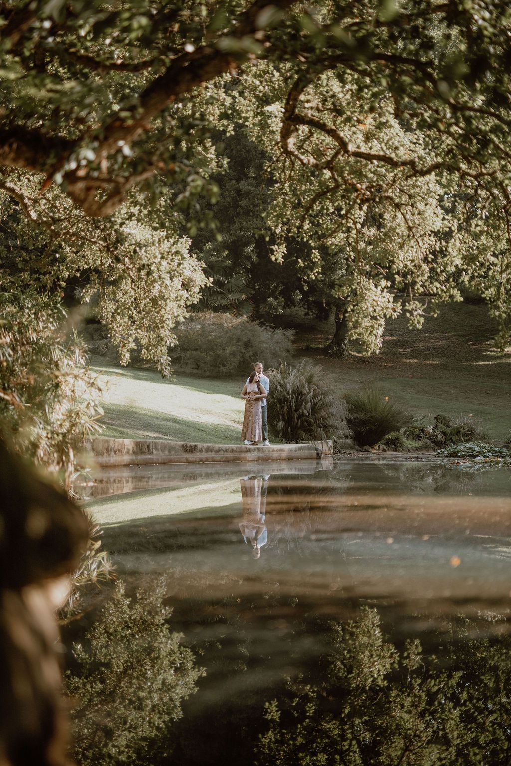 A misty garden scene with flowering trees and a path winding through a tranquil landscape.