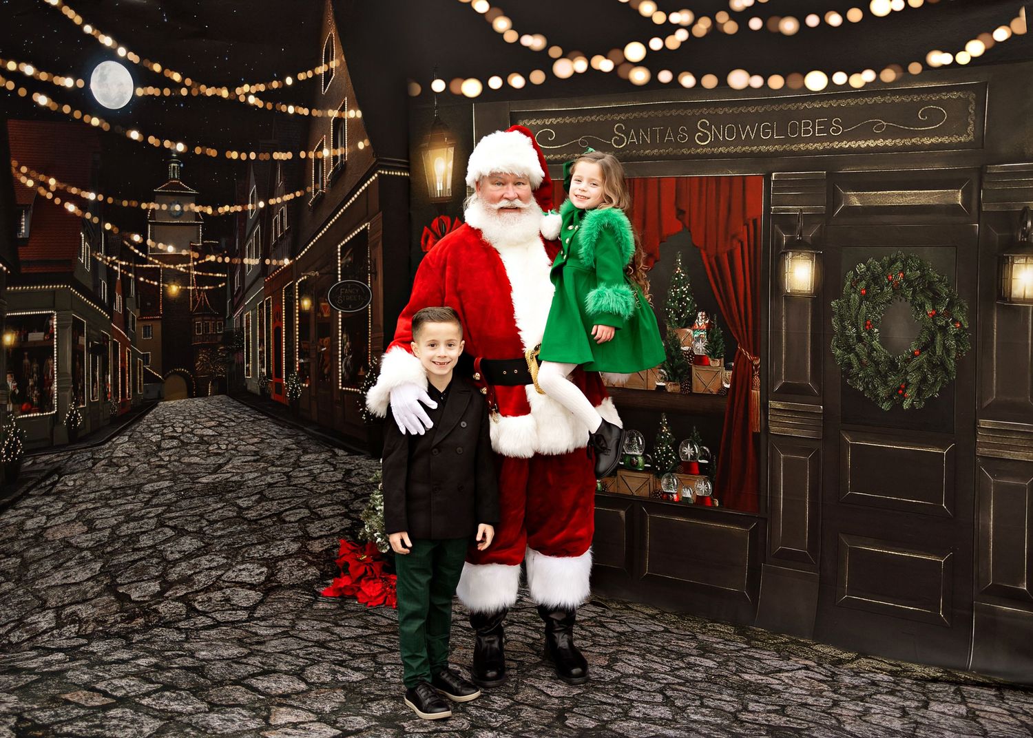 String lights illuminate a stone walkway outside a rustic holiday storefront with festive Christmas decorations.