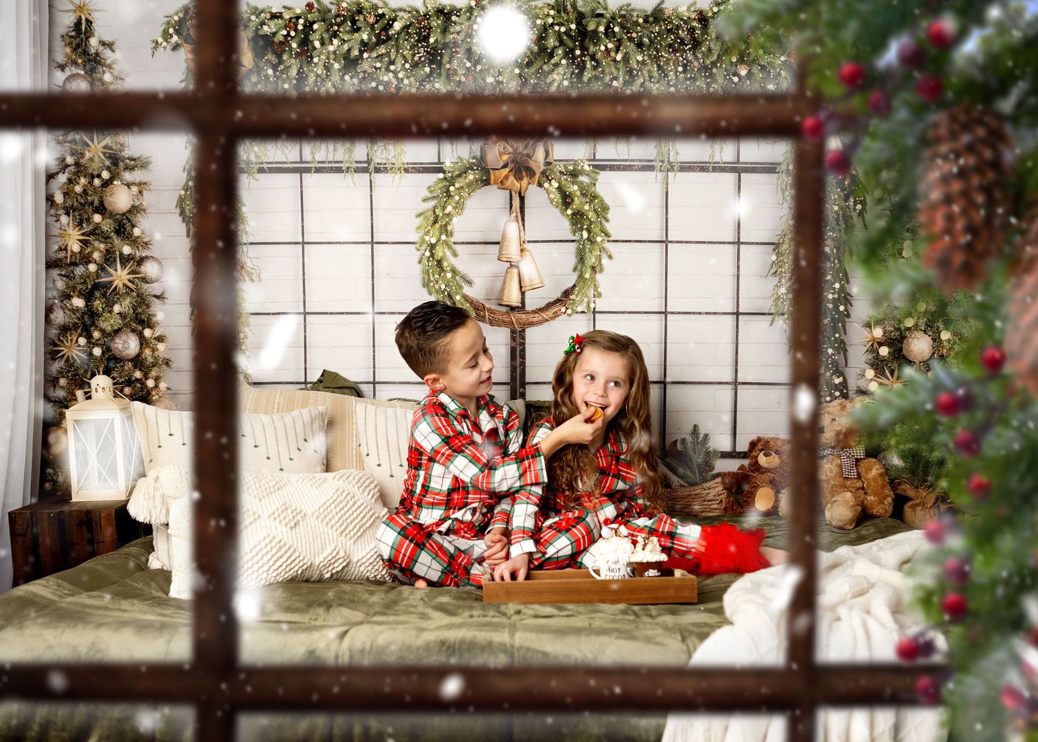 Log cabin window decorated festively for Christmas with pinecones, twinkle lights, and evergreen garland.