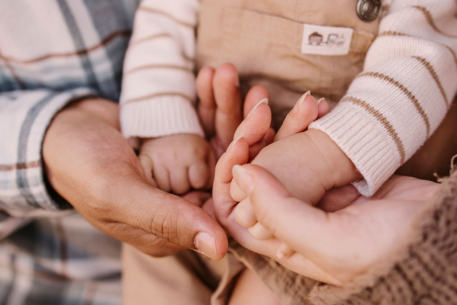 Close-up of gentle hands holding in an intimate moment.
