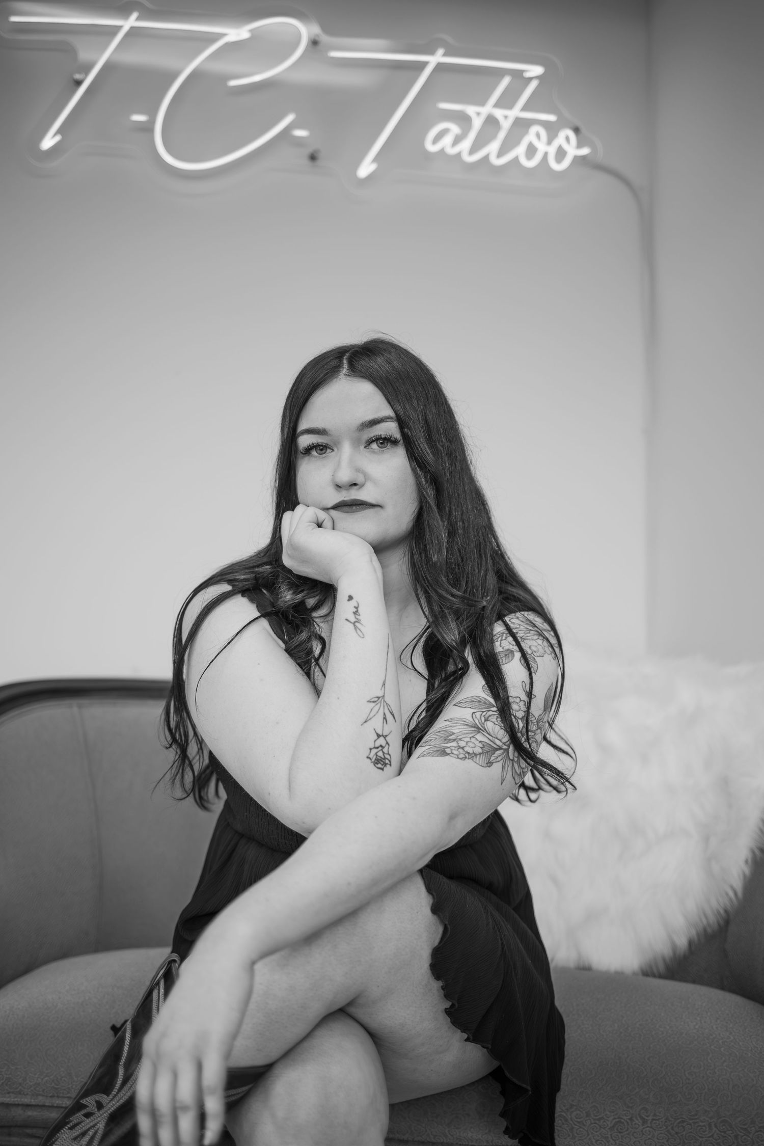 Black and white portrait session with neon sign backdrop.