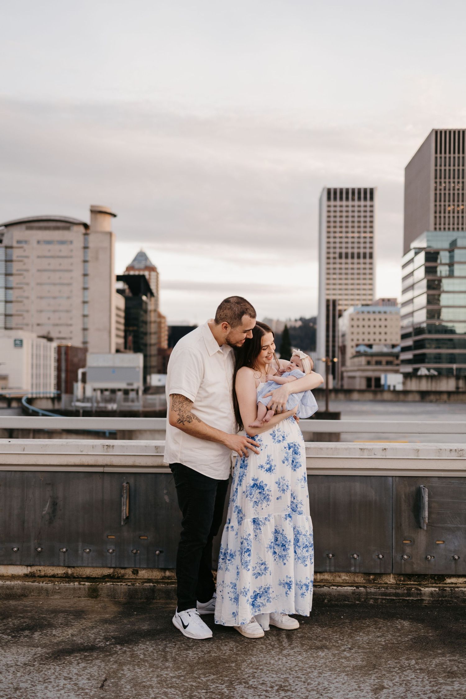 Urban rooftop engagement session with city skyline backdrop in Portland.