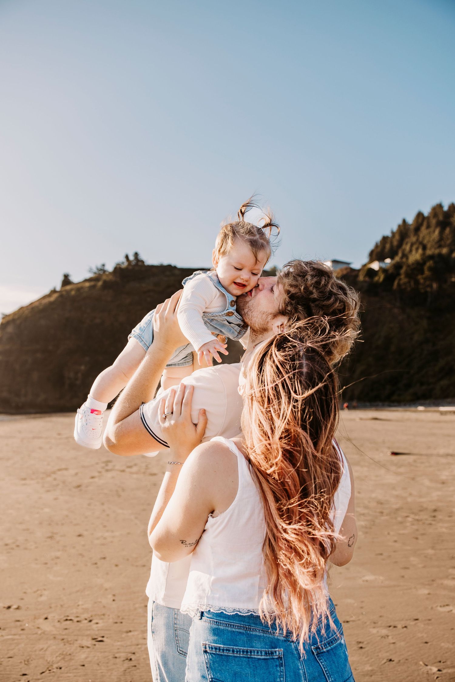 Playful family moment captured in a series of photos at sunset on a beach with joyful expressions and movement.