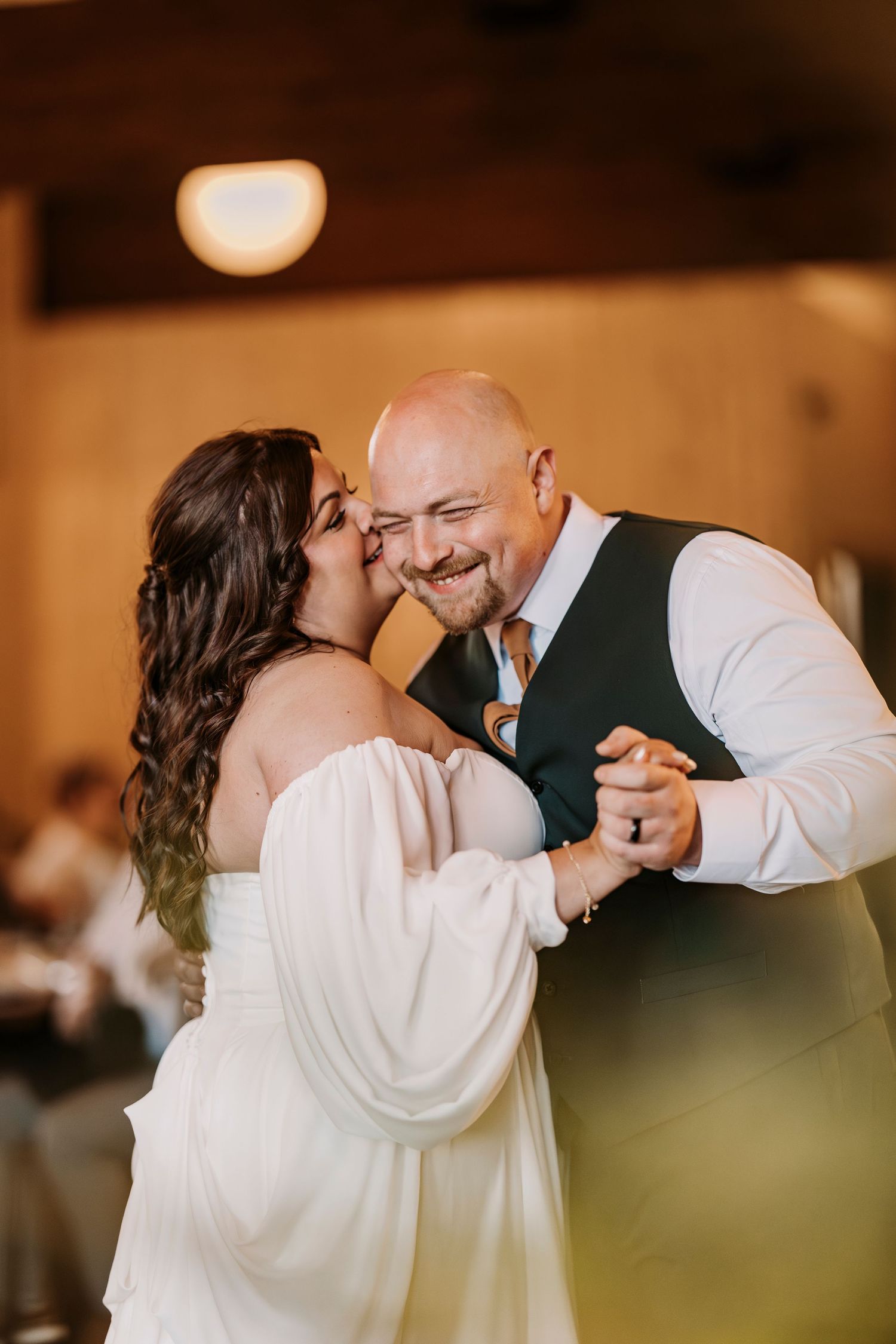 Romantic moment between newlyweds during their first dance at the reception.