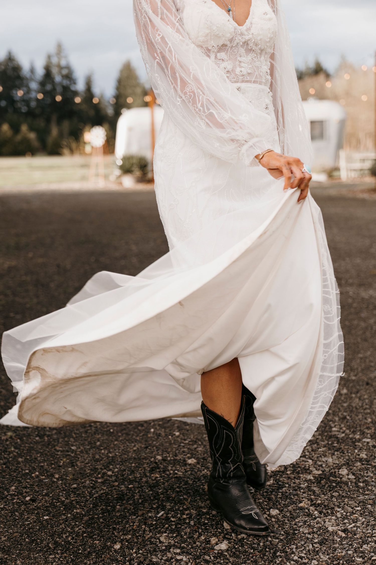 White lace dress and black boots detail shots against dark ground.
