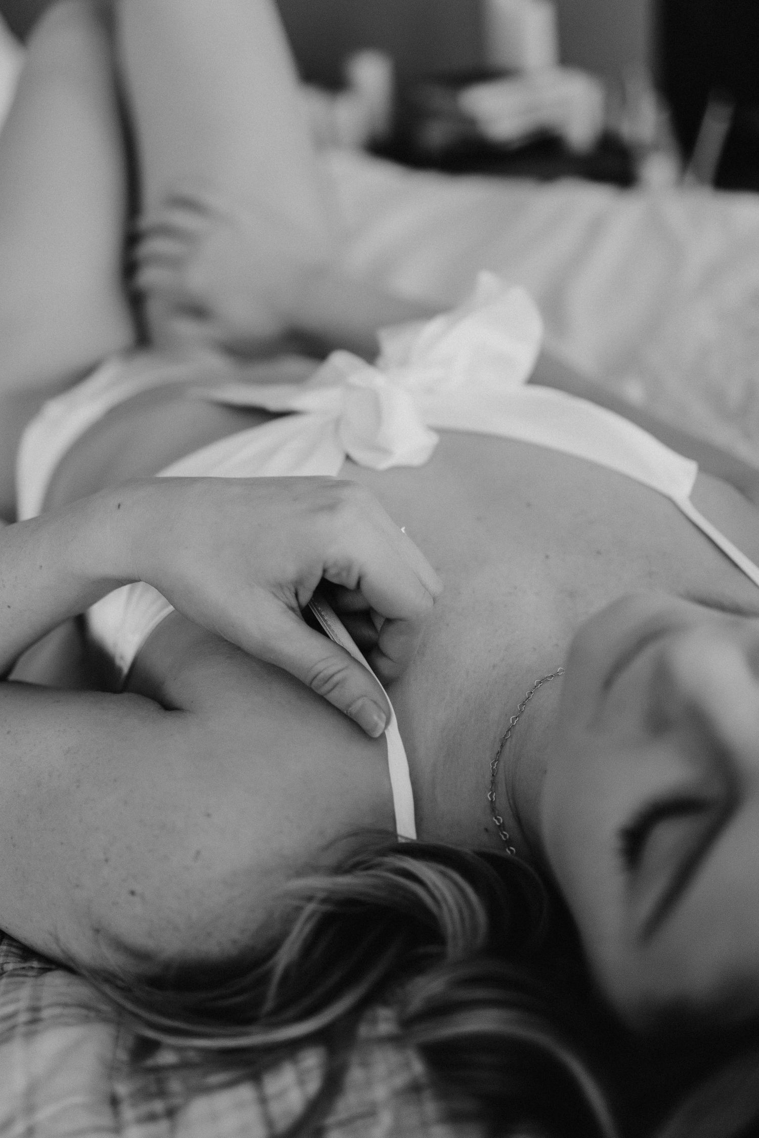 Black and white intimate portrait series with dramatic shadows.