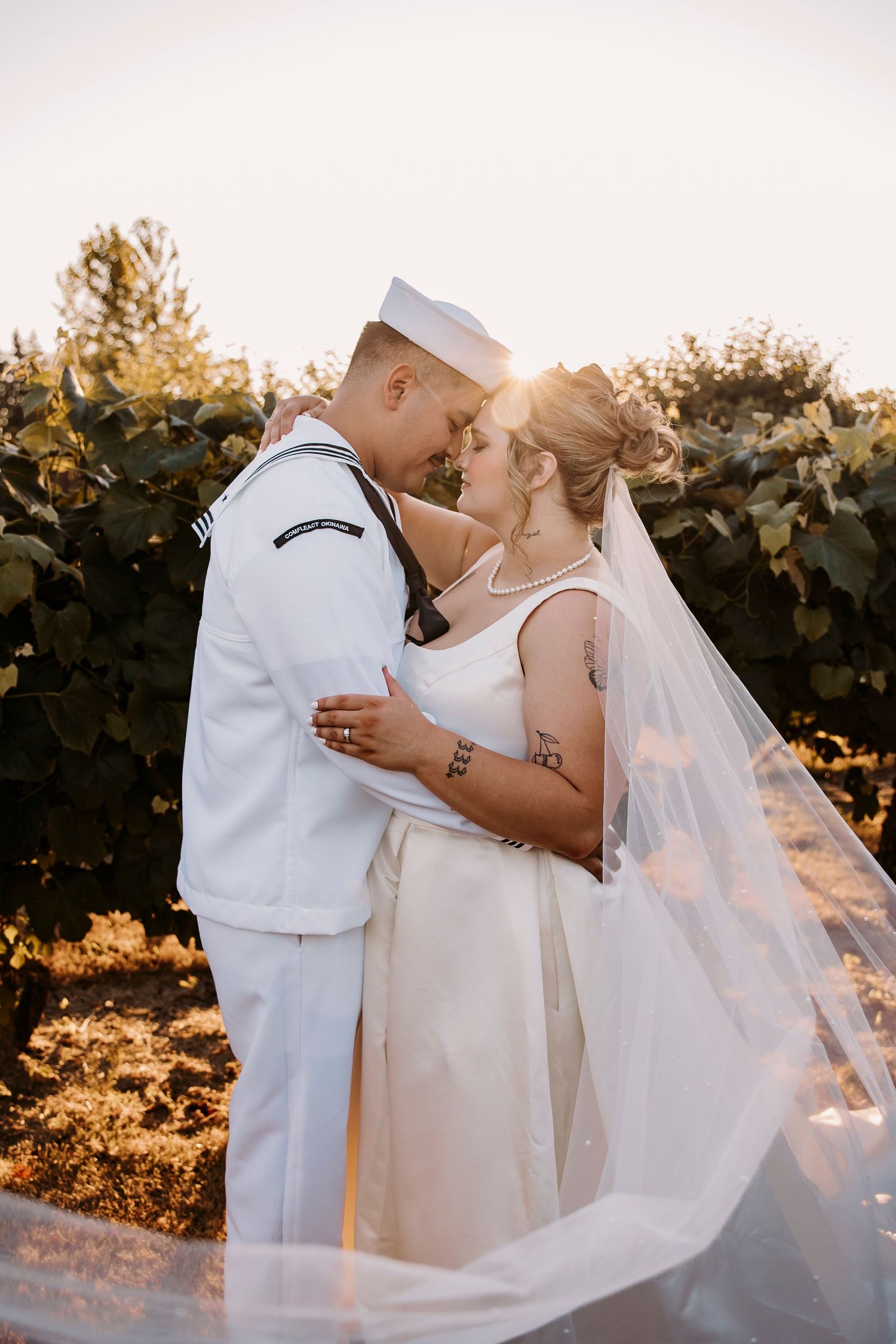 Military wedding couple shares romantic kiss during golden hour.