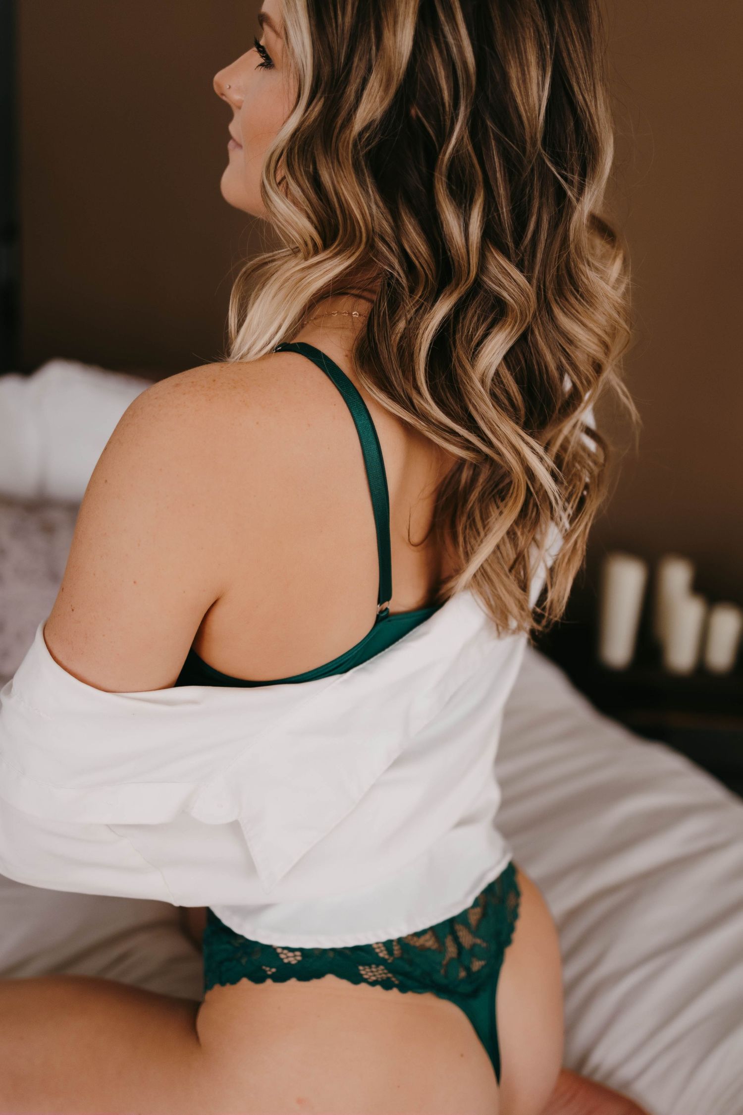 Intimate portrait series showing emerald lingerie and white sweater details.