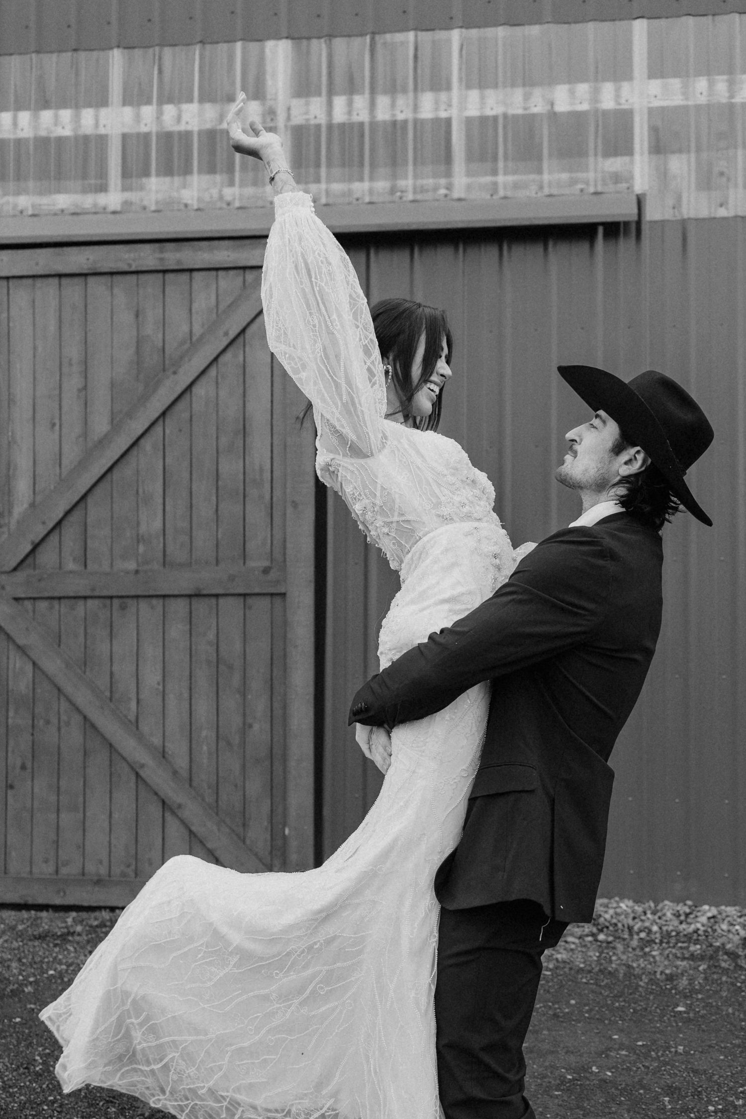 Black and white sequence of a couple's playful interaction against a barn wall.
