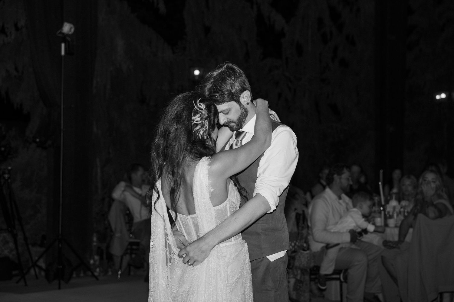 Black and white wedding reception dance floor moments captured in low light.