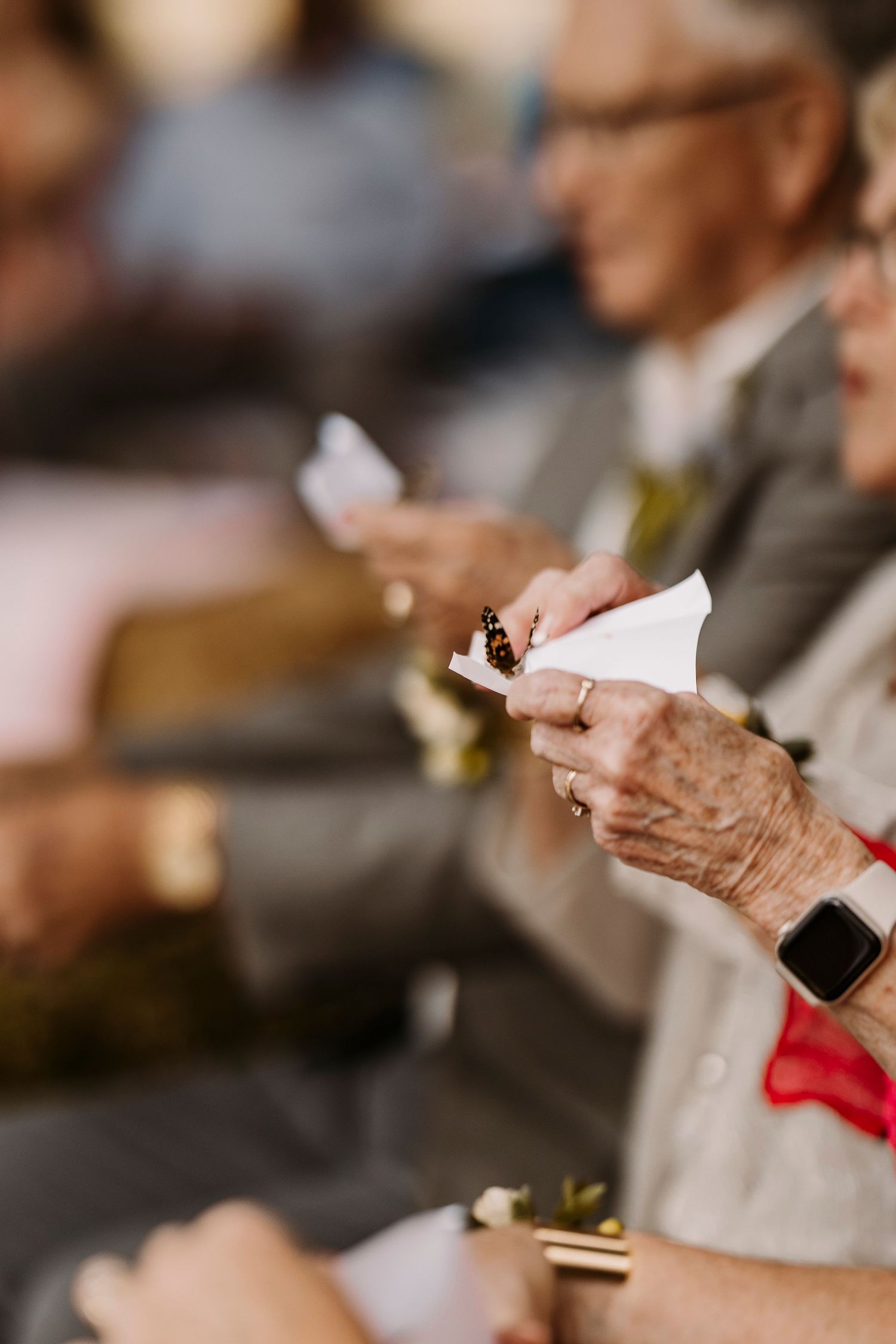 Row of hands holding sparklers during an evening wedding celebration.