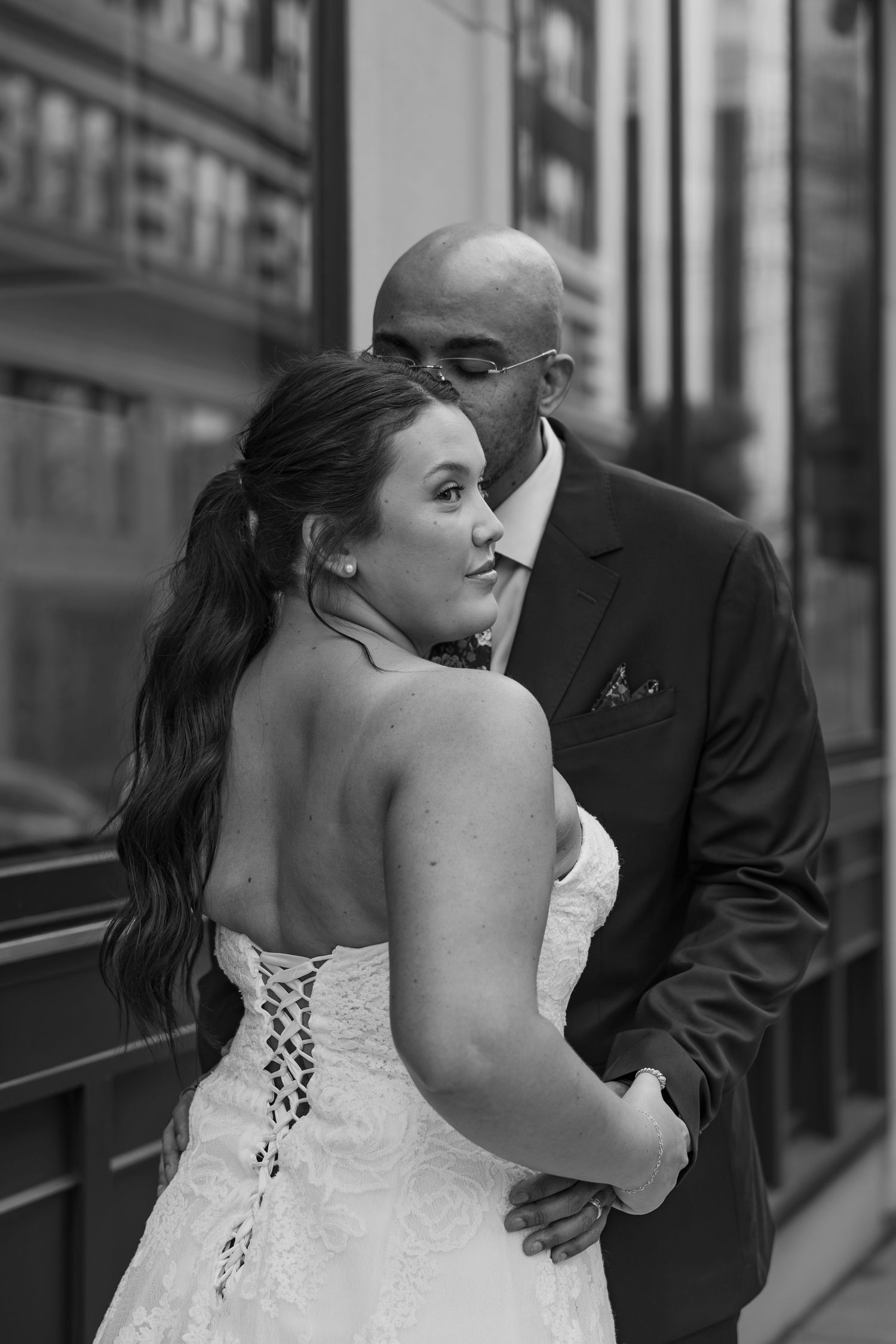 A romantic black and white photo sequence of a bride and groom sharing a tender kiss on their wedding day.