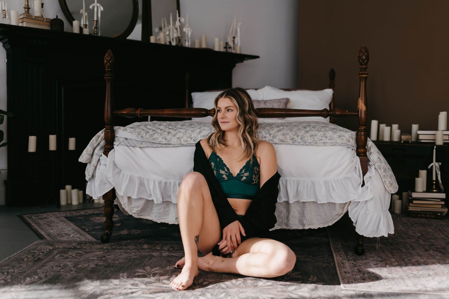 Artistic boudoir photography session in minimalist bedroom setting.