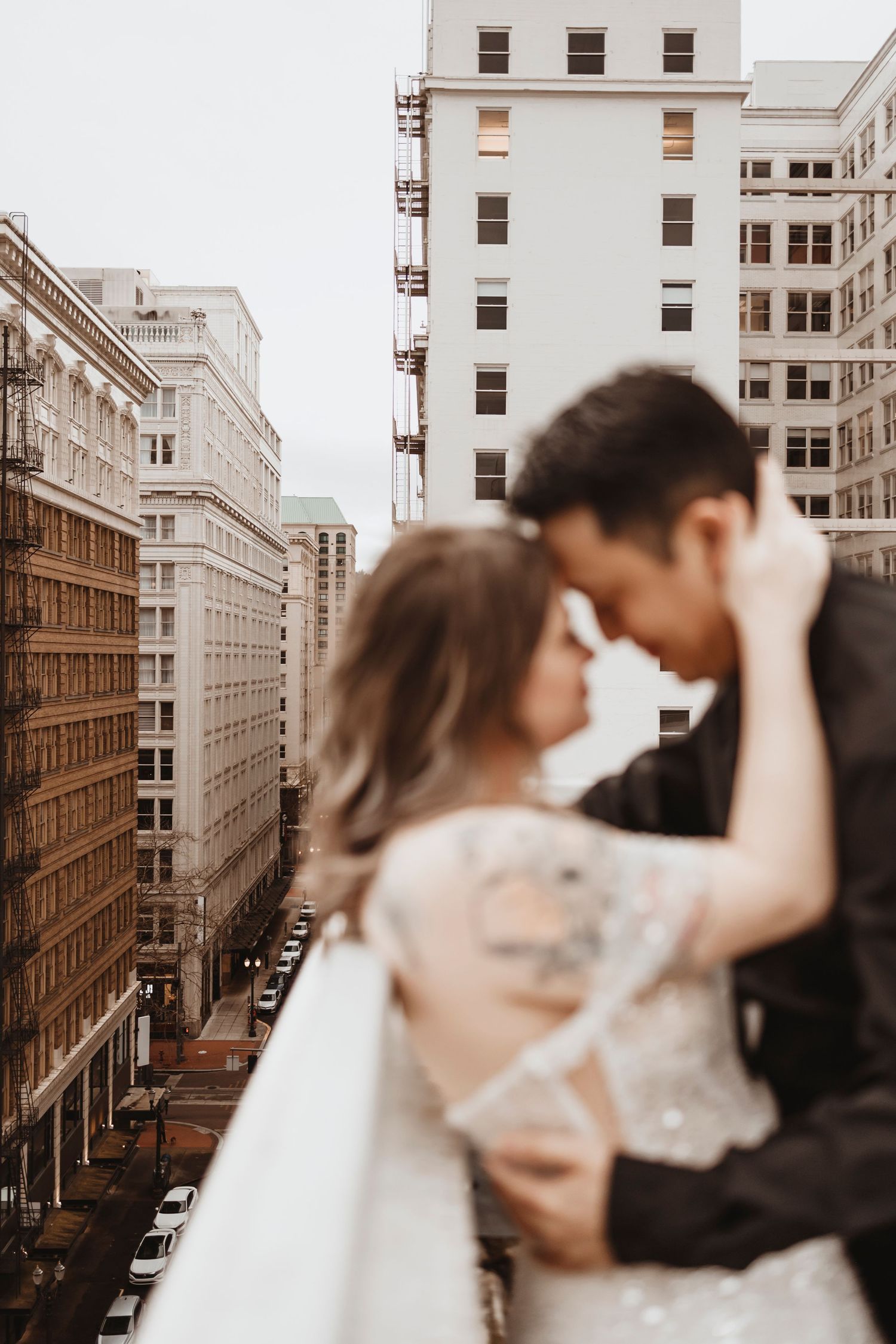 Romantic couple portraits against historic downtown architecture.
