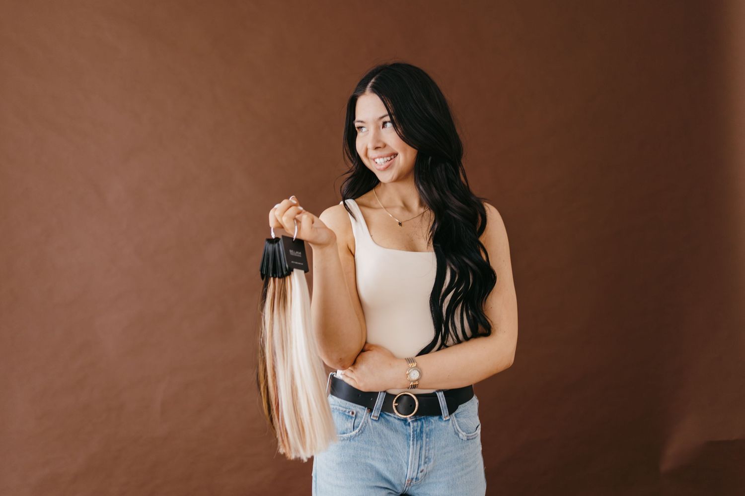 Lifestyle photoshoot featuring casual poses against brown backdrop.