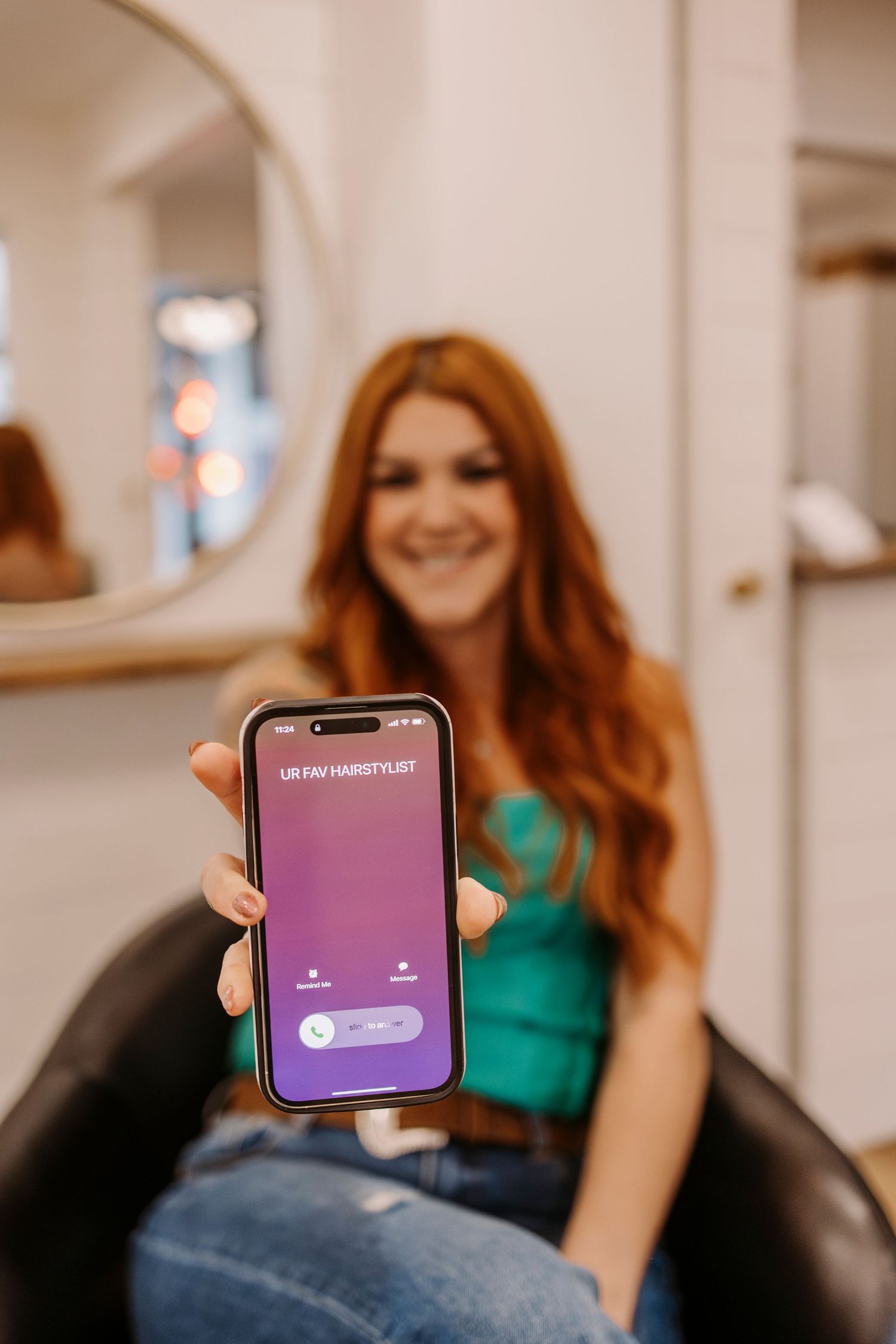 Mobile phone displaying app interface in warm indoor lighting.