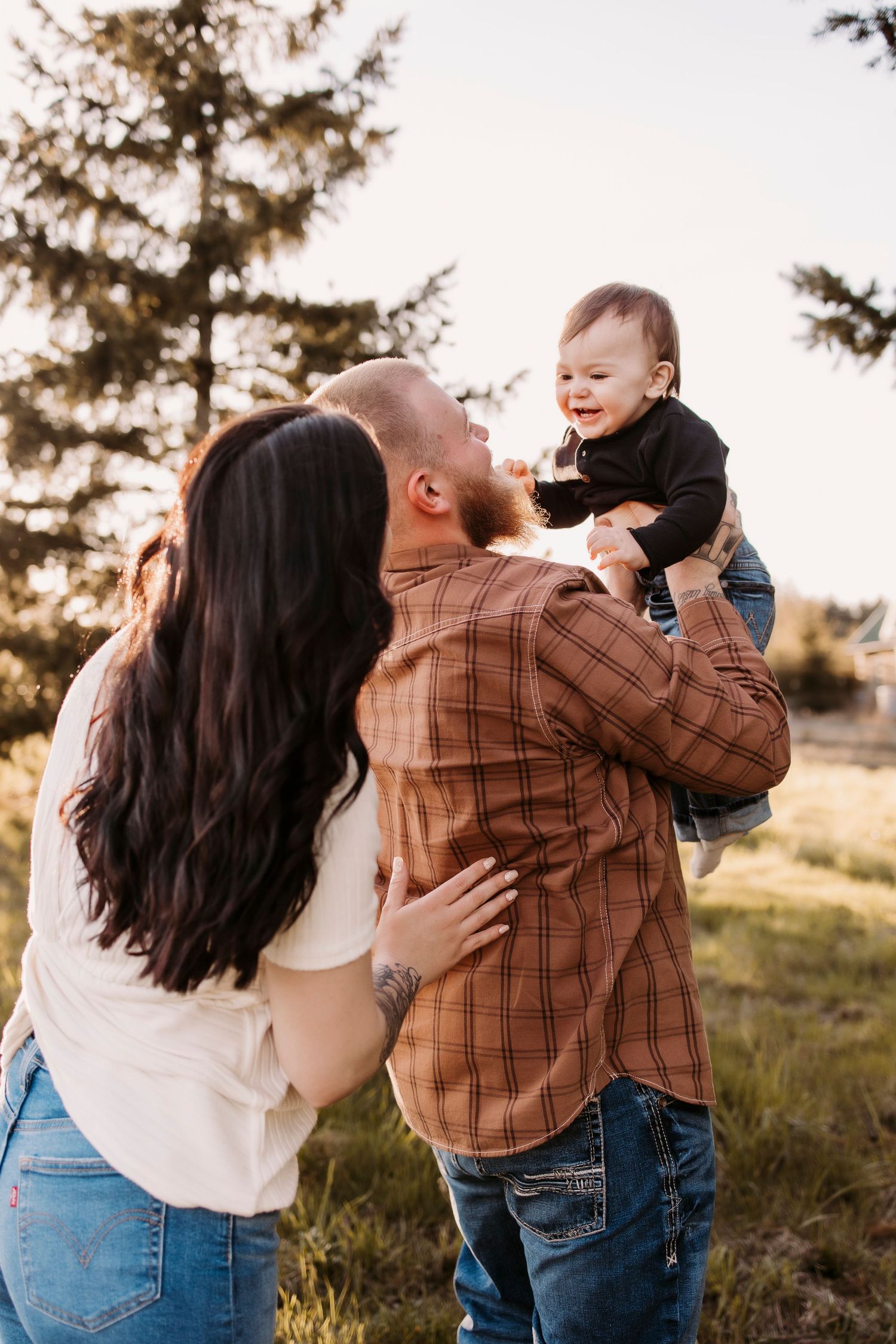 Family sharing joyful moment together in outdoor setting during golden hour.
