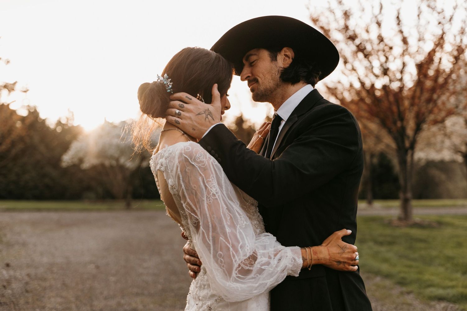 Intimate wedding couple portraits in warm sunset lighting.