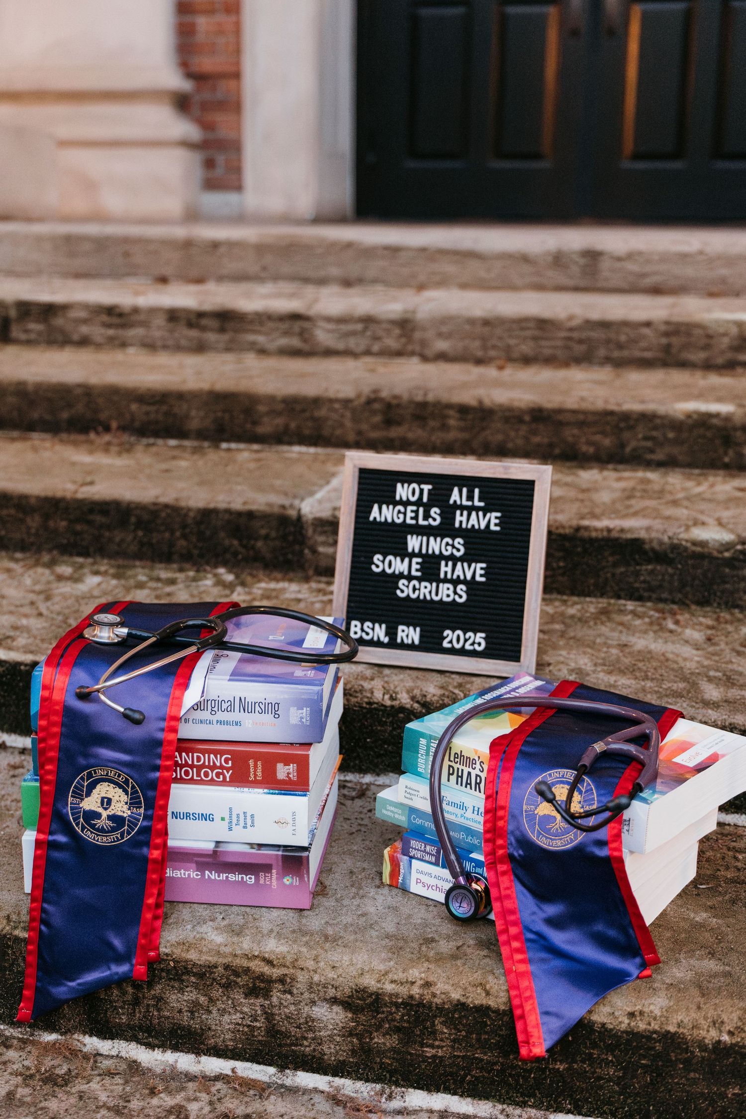 Graduation memorabilia and signs arranged on stone steps.