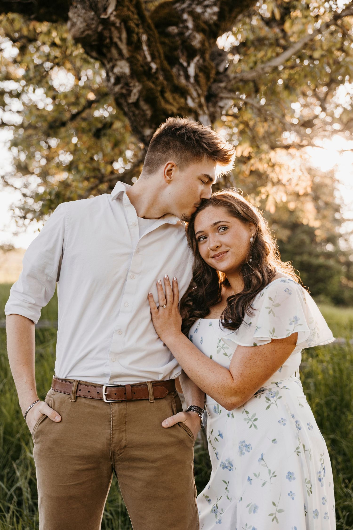 Romantic golden hour couple portraits in blooming garden setting.