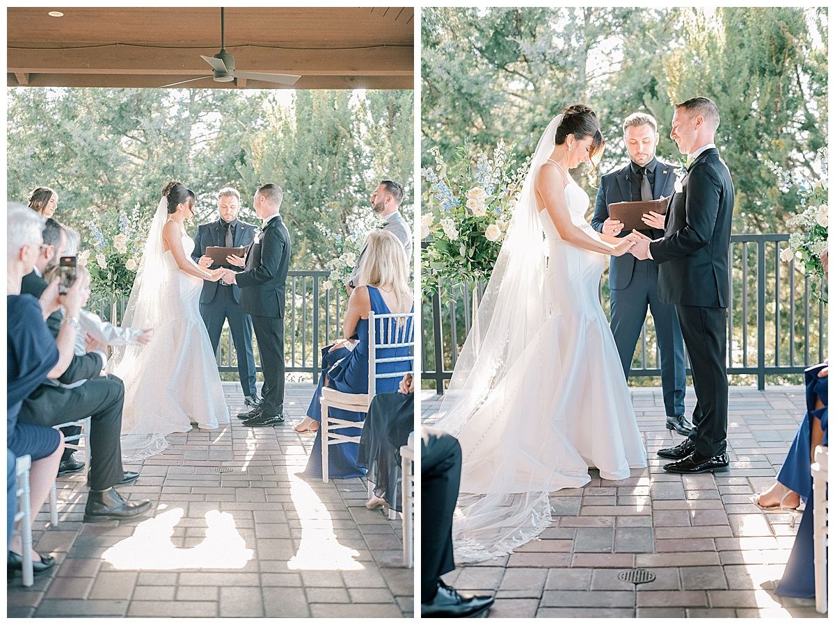 An outdoor wedding ceremony takes place on a covered patio surrounded by greenery.
