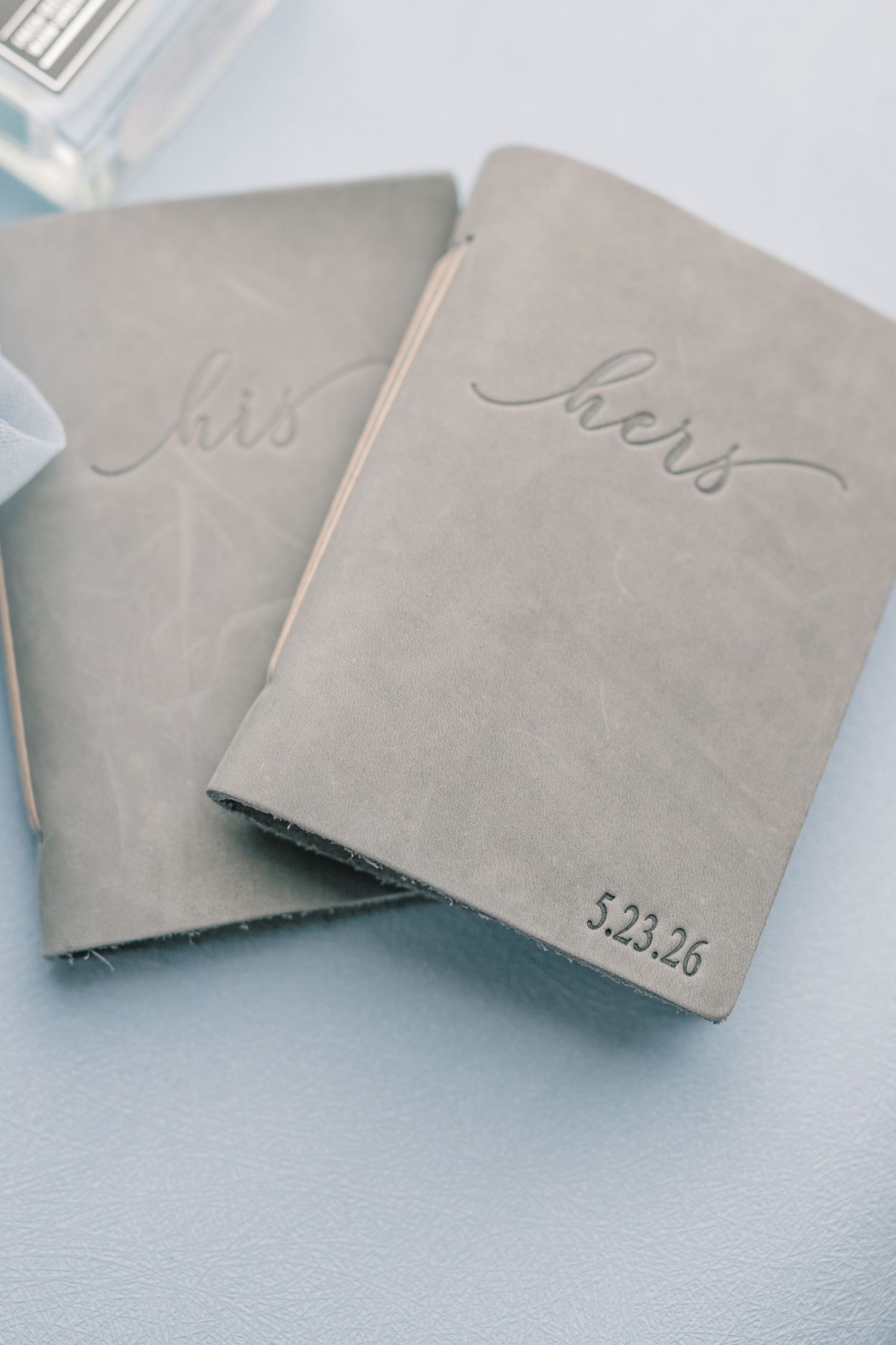 His and hers gray leather wedding journals embossed with cursive script and wedding date 5.23.26.