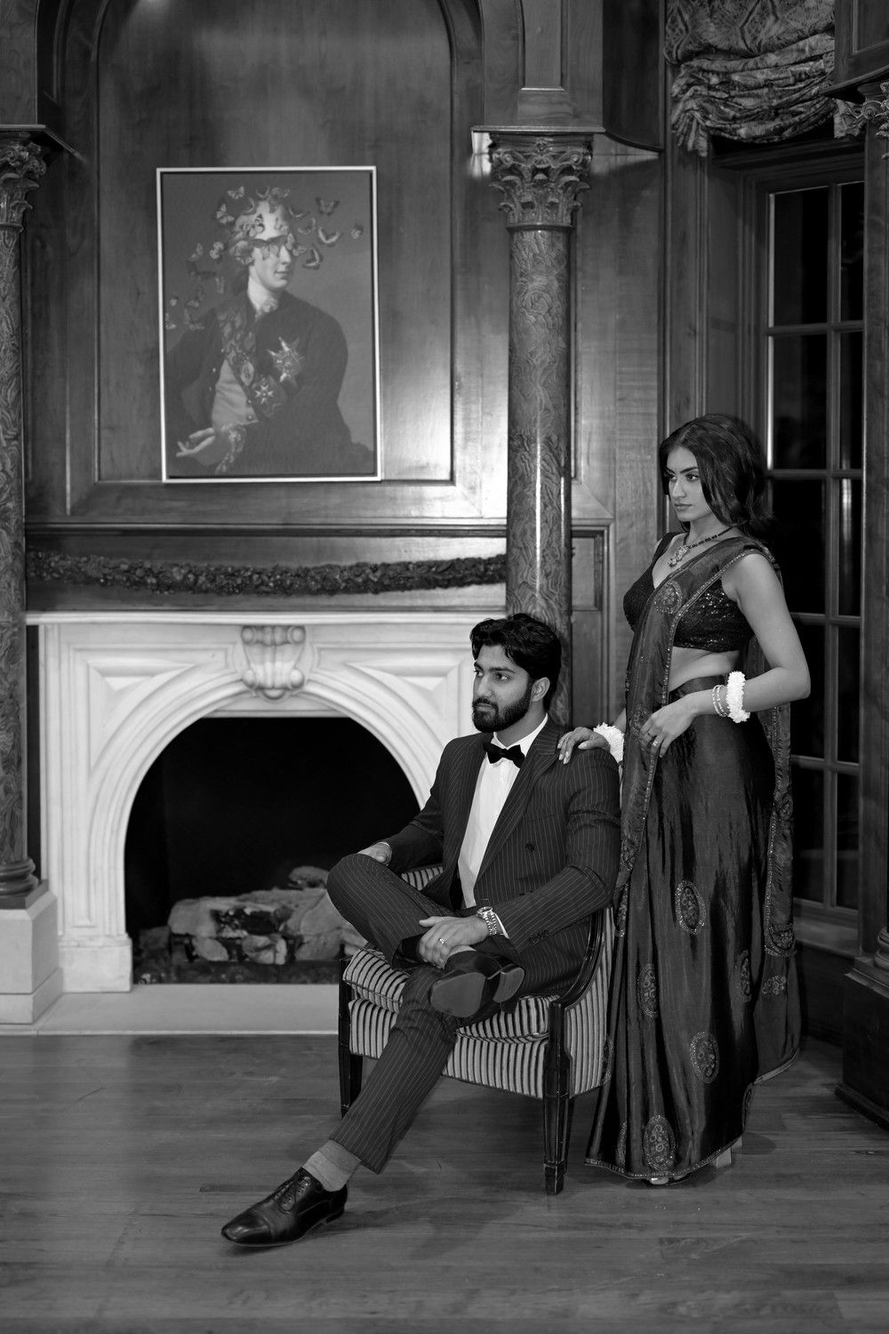 Black and white portrait session in vintage ballroom with classical architectural elements.