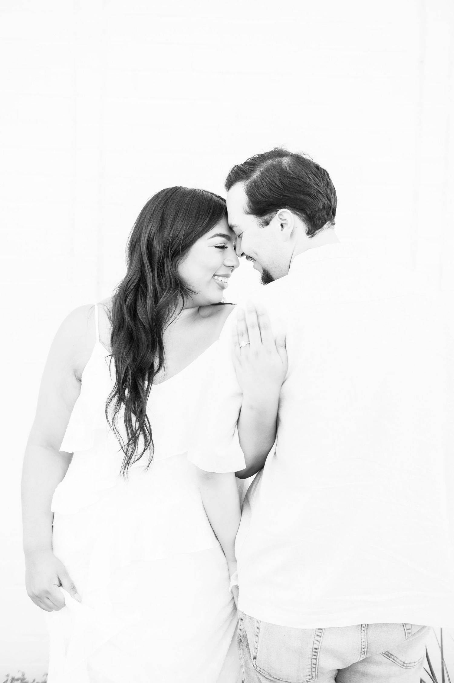 Black and white photo sequence showing a romantic couple embracing and leaning back in a tender dance-like motion.