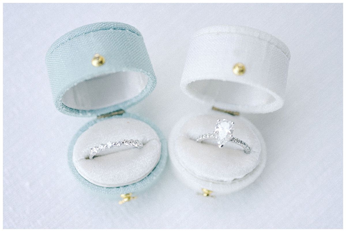 Light blue and white ring boxes arranged in a minimalist product photography style.