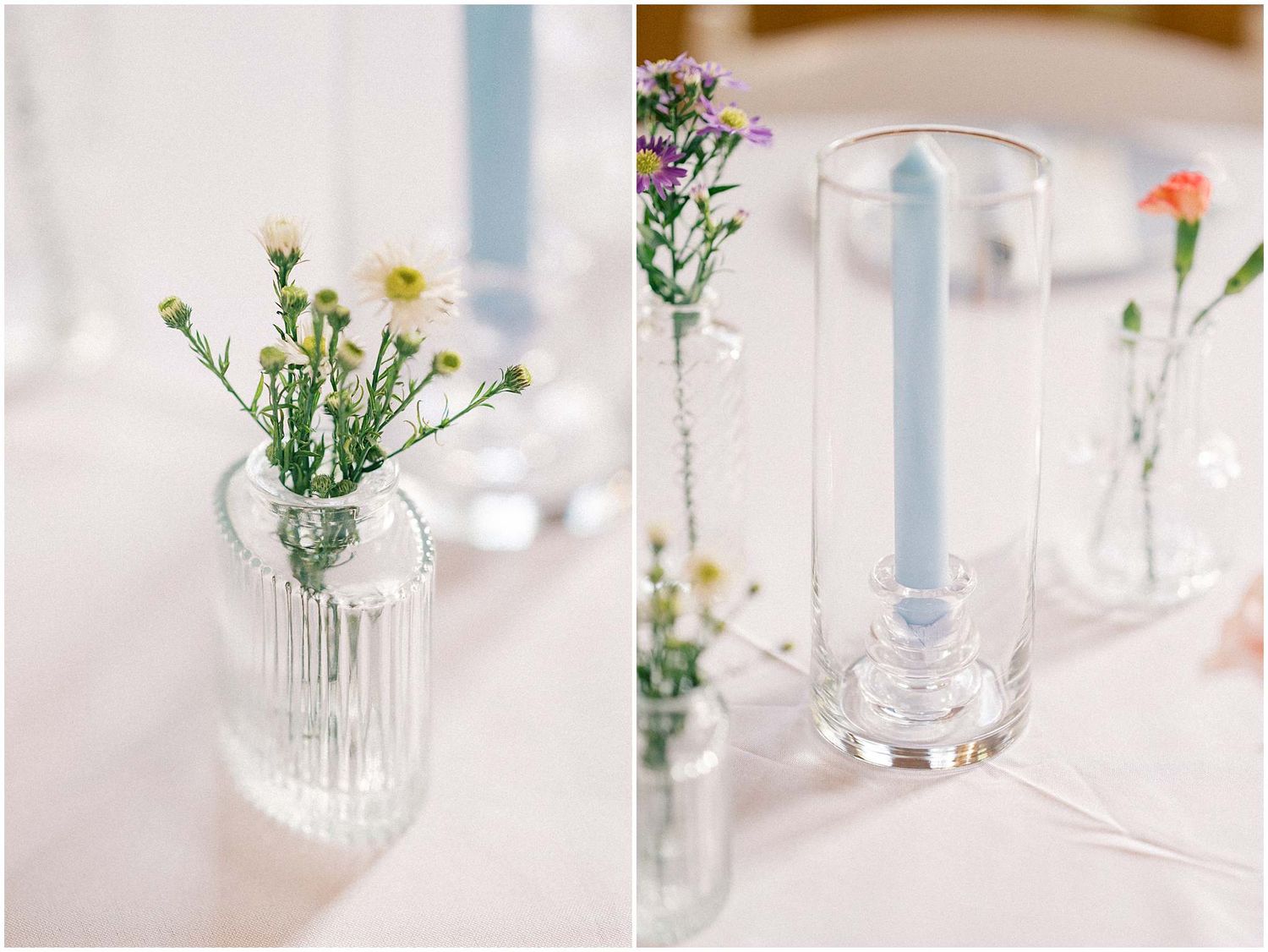 Small glass vases with delicate wildflowers and blue candles create an elegant minimalist table centerpiece arrangement.