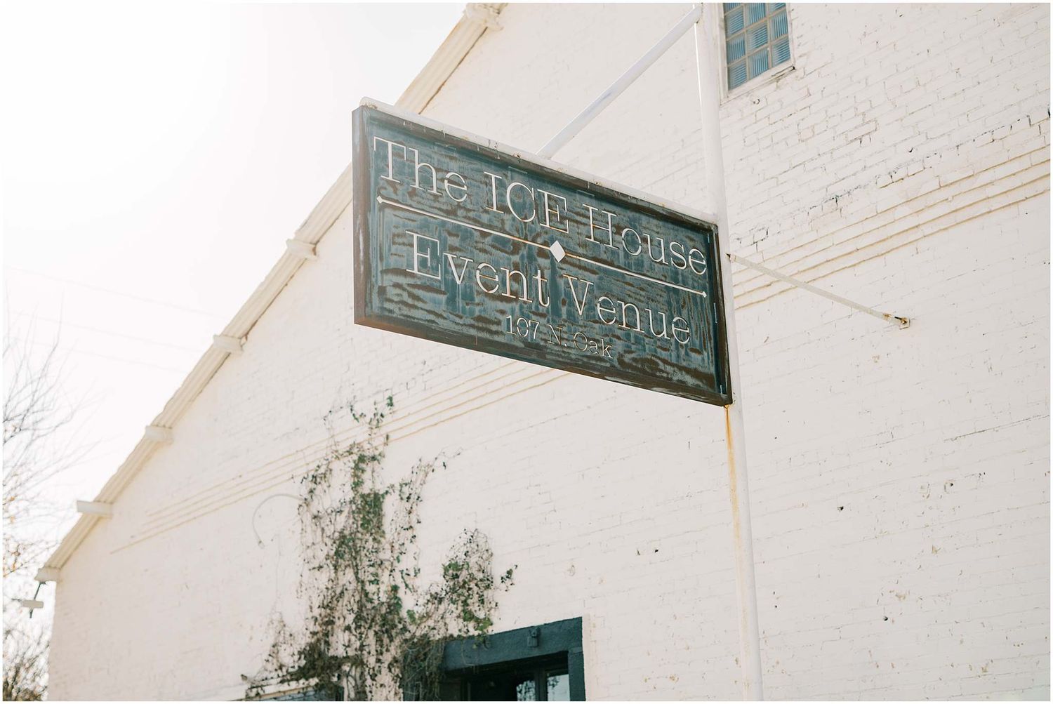 Exterior signage of The Ice House venue with white painted brick walls.