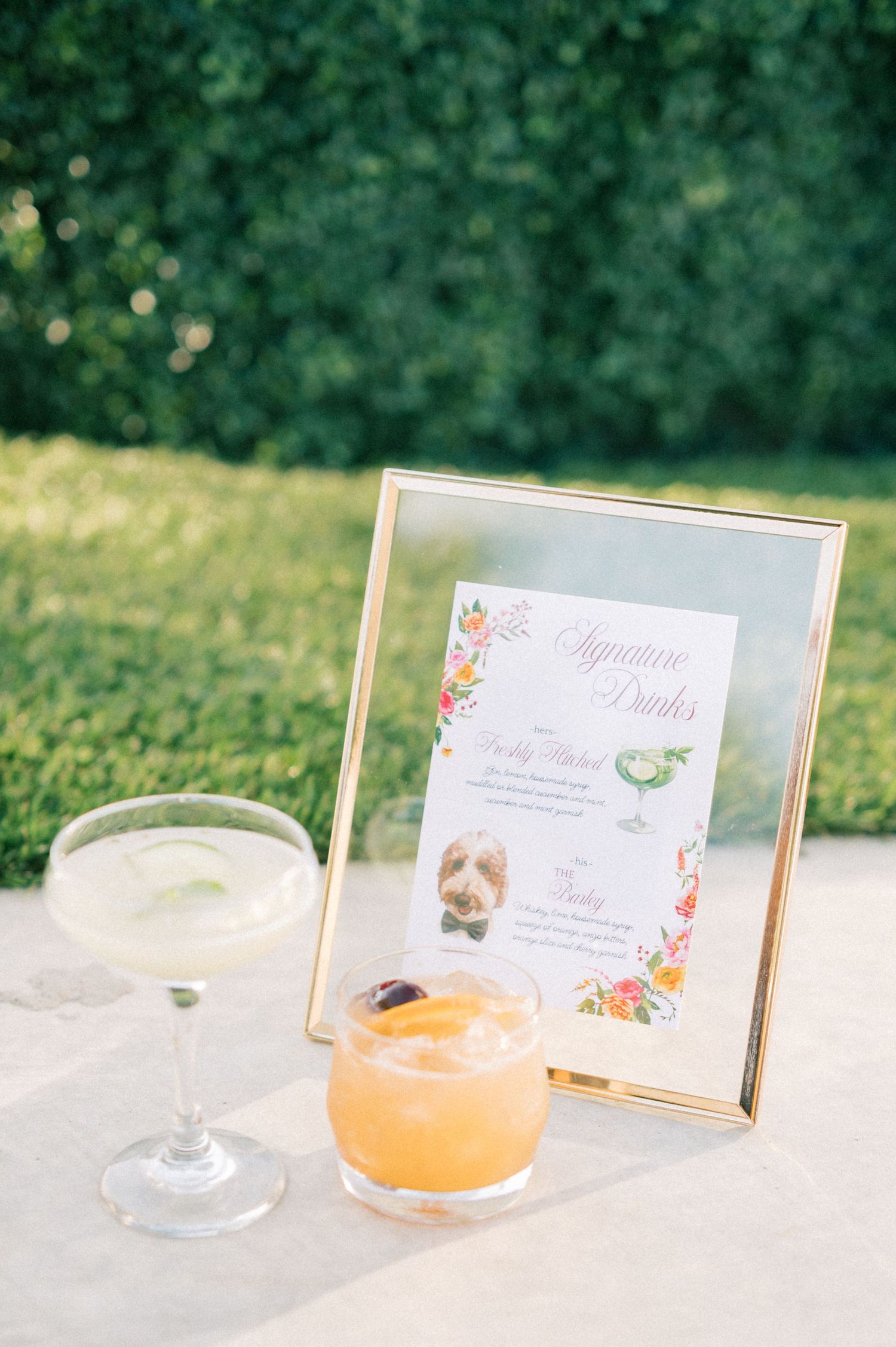 Orange signature cocktails with menu cards displayed on an elegant table setting.