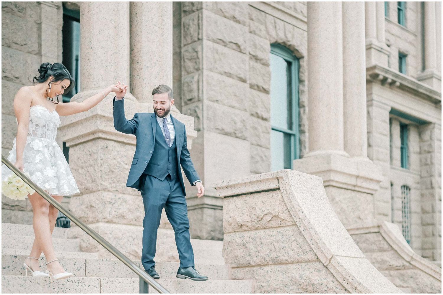 Romantic wedding photos captured on grand stone steps of a historic building.
