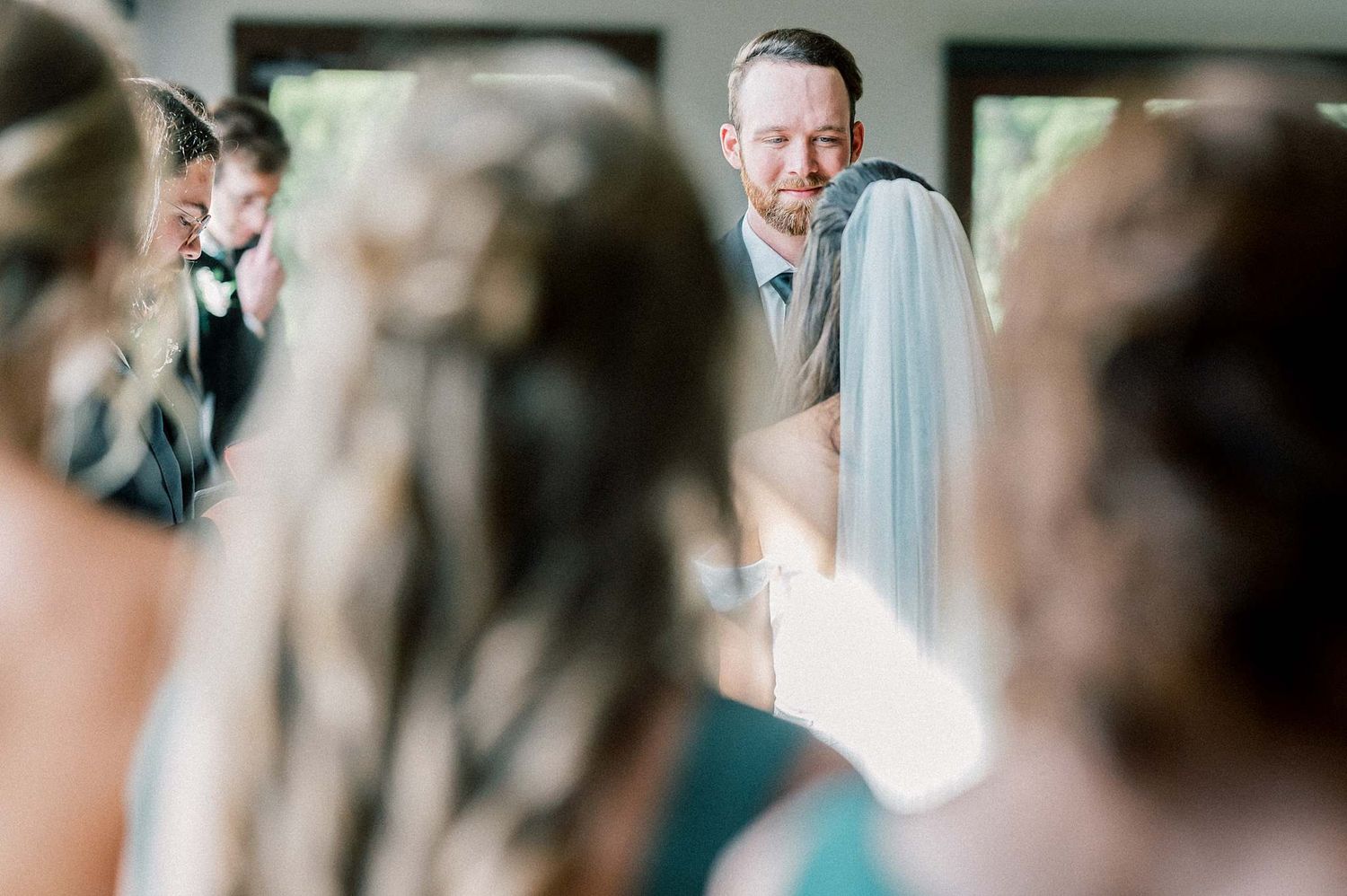 Intimate wedding ceremony moments captured in a light-filled indoor space.