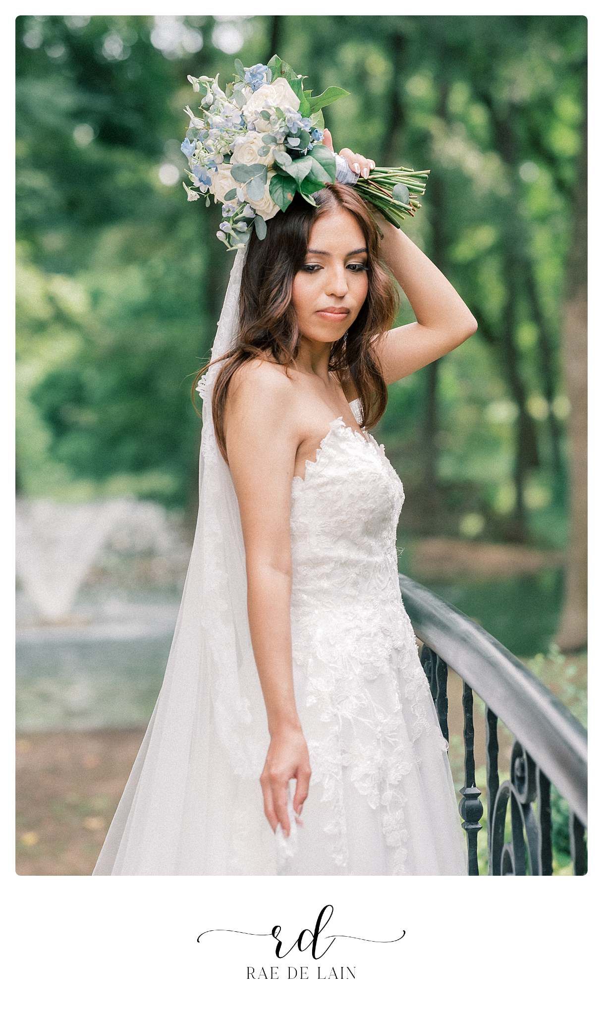 Beautiful bridal portrait in a white lace dress against a green forest background.