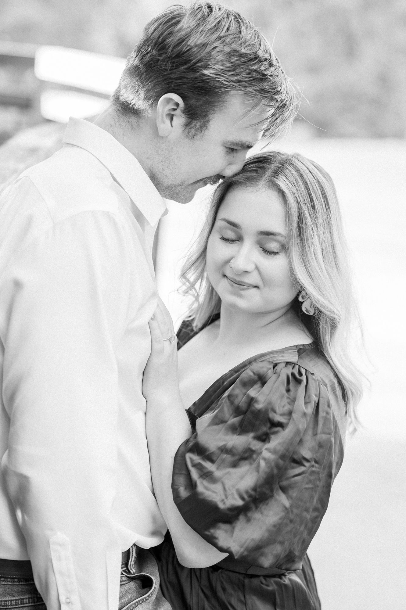 A romantic black and white portrait series showing a couple in an intimate embrace.