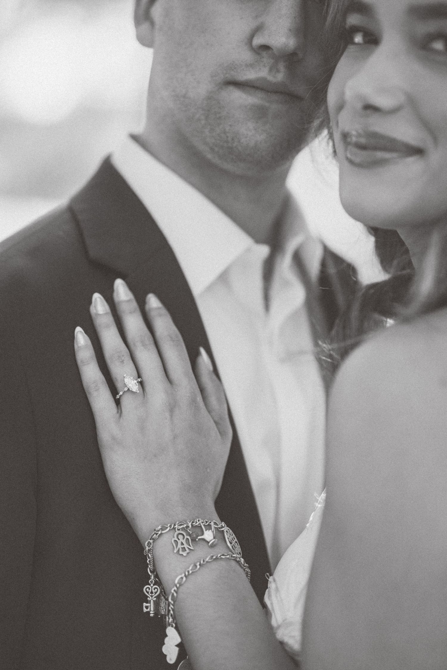 Close-up black and white photo series showing an engagement ring and bracelet on a woman's hand.