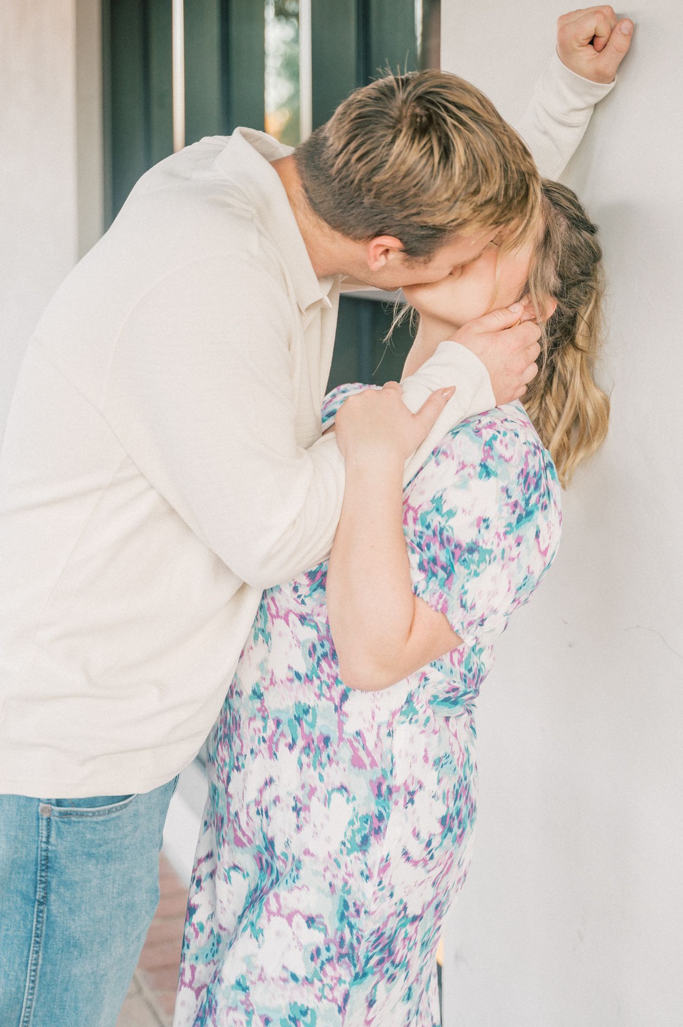 A sequence showing a romantic dip dance move against a white wall background.