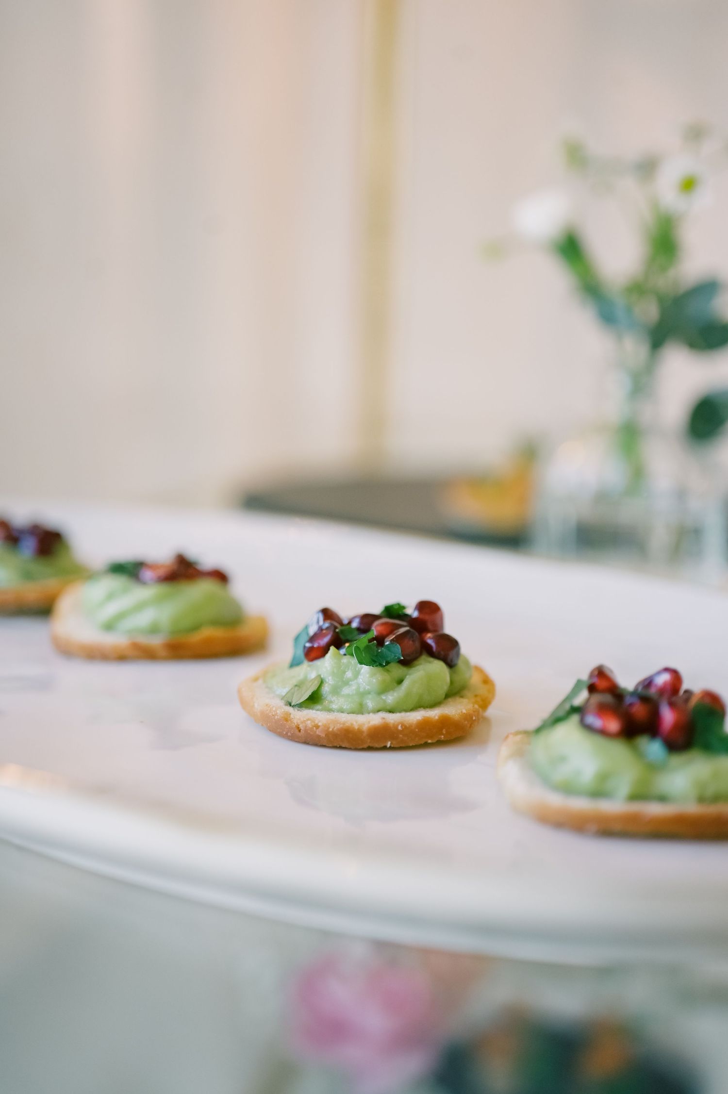 Elegant appetizer plates featuring green mousse topped with garnish.