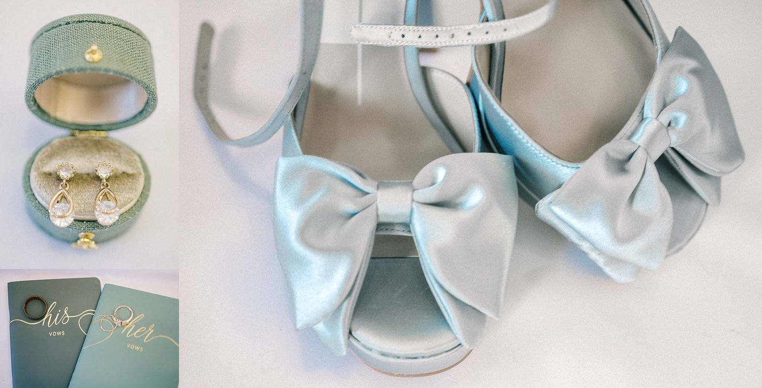 Delicate wedding rings and jewelry displayed in soft blue vintage boxes.