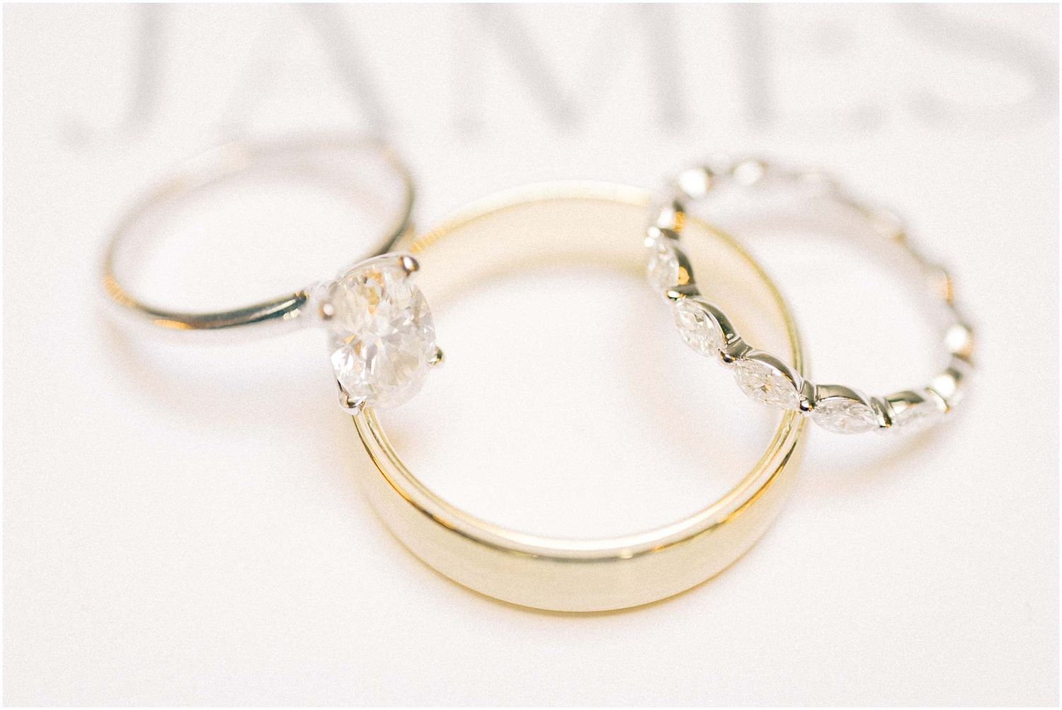 Close-up shots of elegant wedding rings in gold and silver tones on white surface.