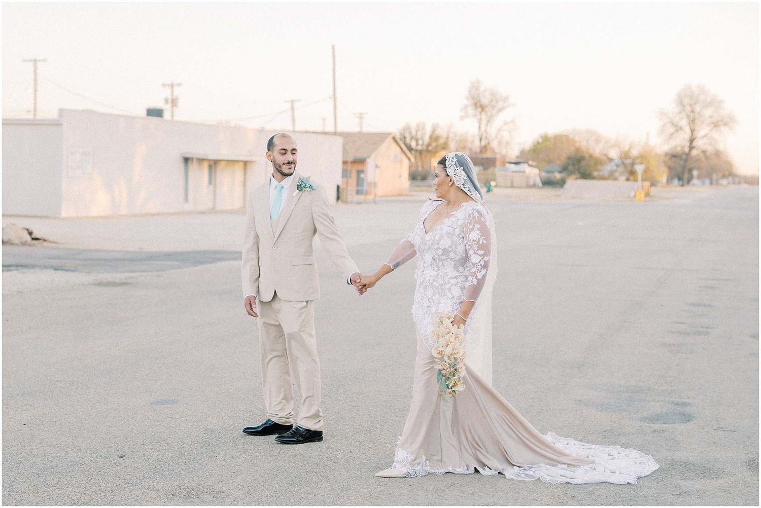 Desert wedding photography captures romantic moments between couple in soft natural light.