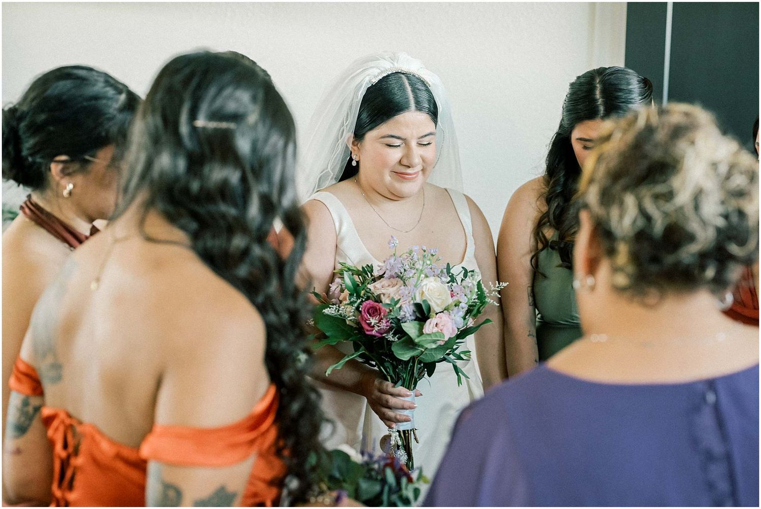 Wedding party members share candid moments and laughter during pre-ceremony preparations.