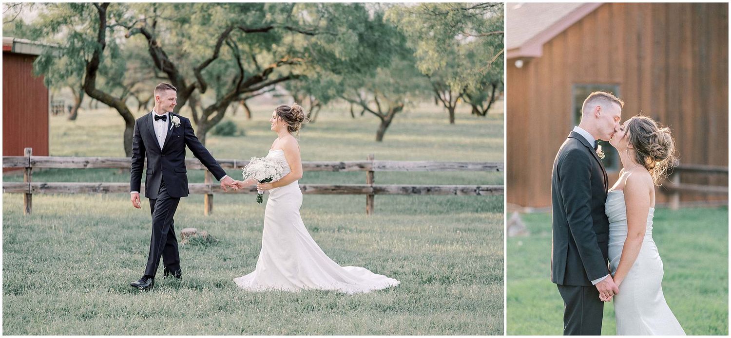 Wedding couple poses together in a rustic outdoor setting with trees and a barn in the background.