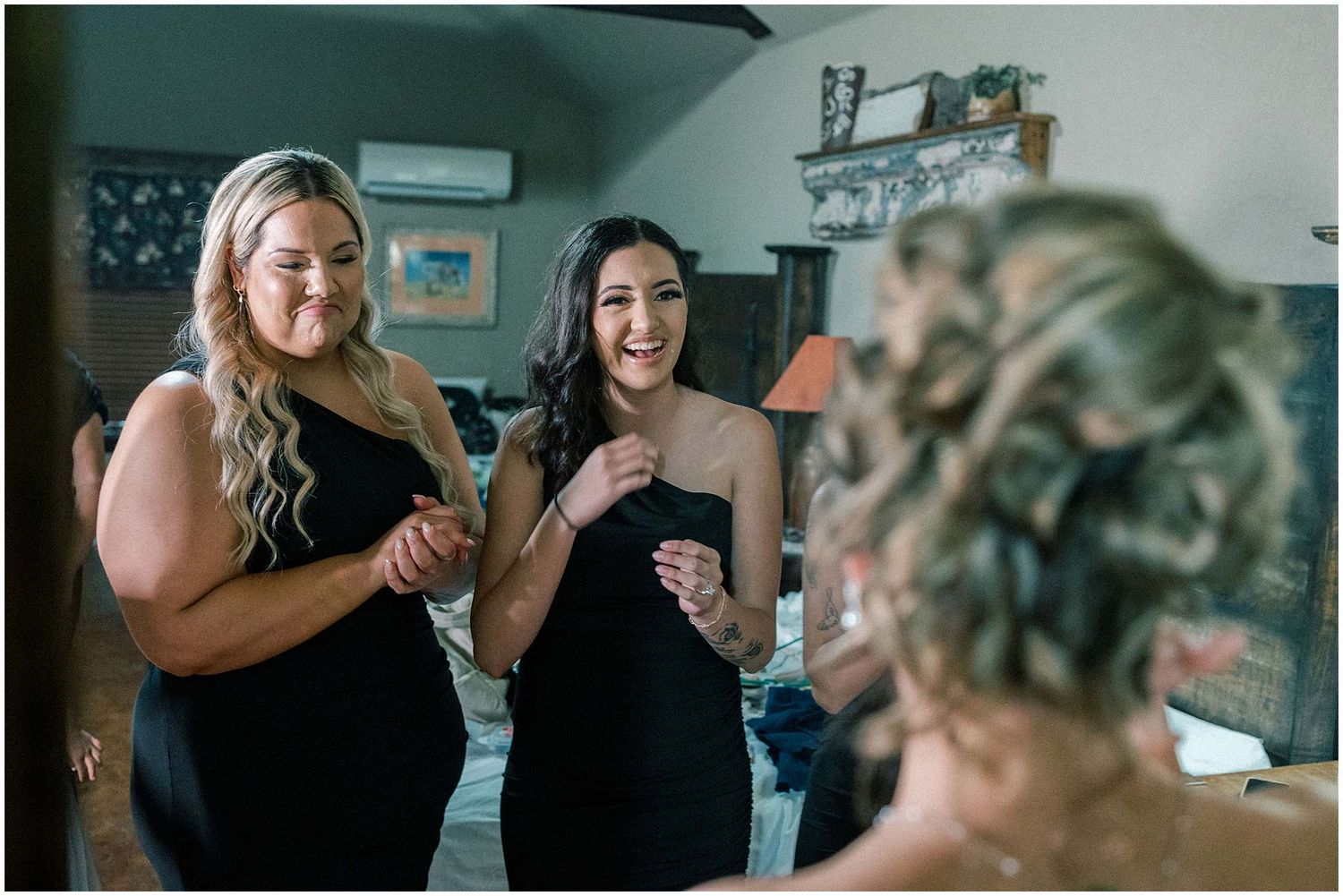 Wedding party members help with final preparations in an indoor venue.
