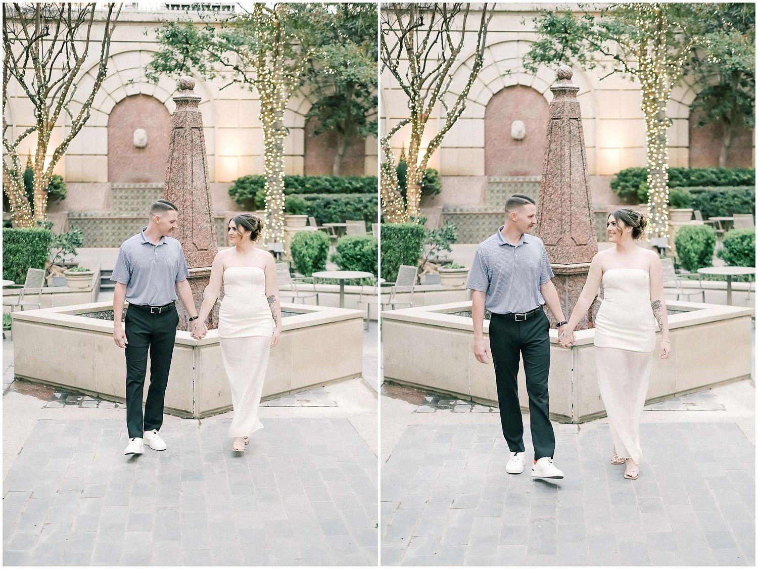 A couple holding hands while walking through an elegant courtyard with stone architecture and greenery.