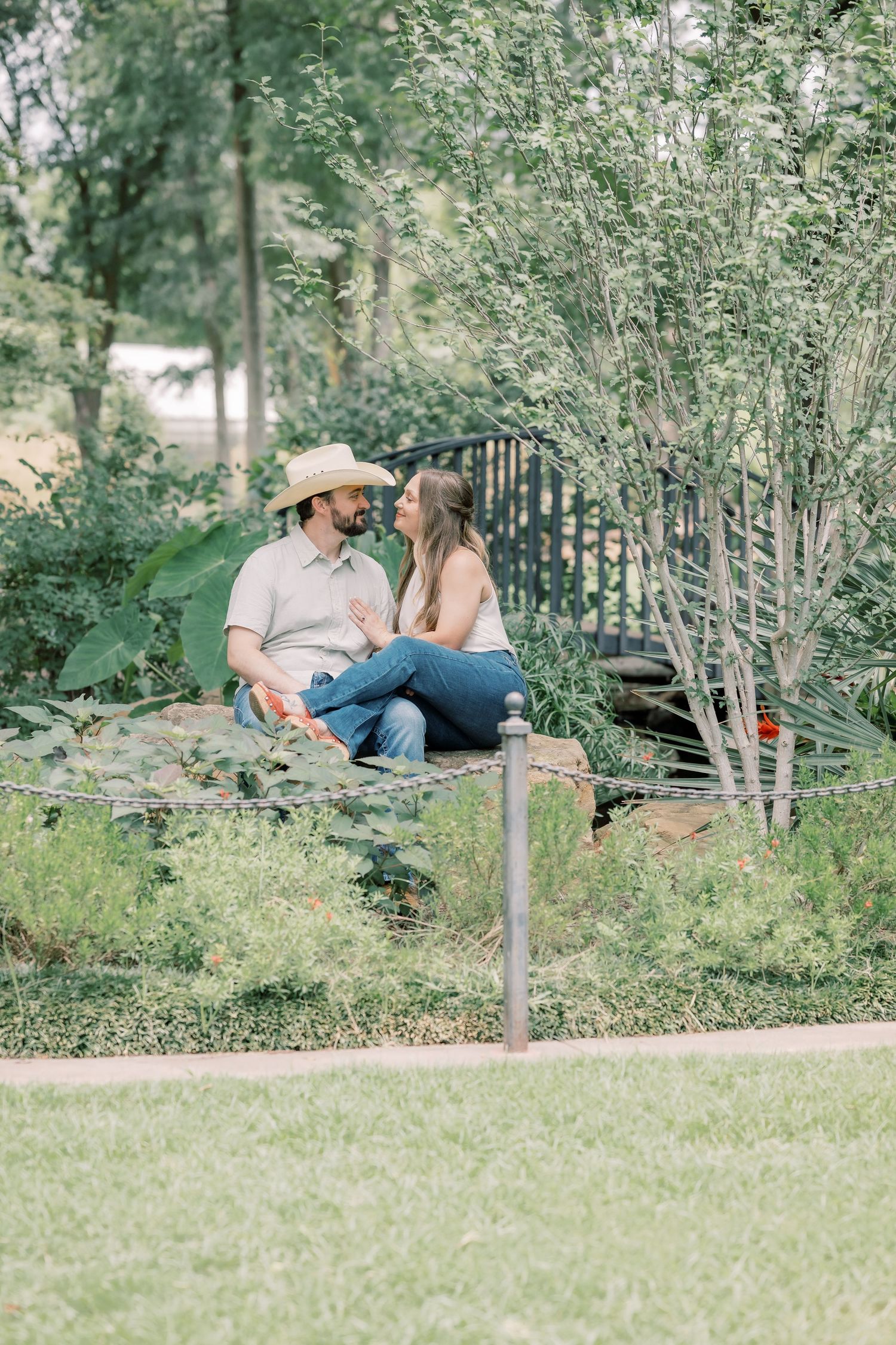 Couple sitting together in a lush garden, sharing a quiet conversation.