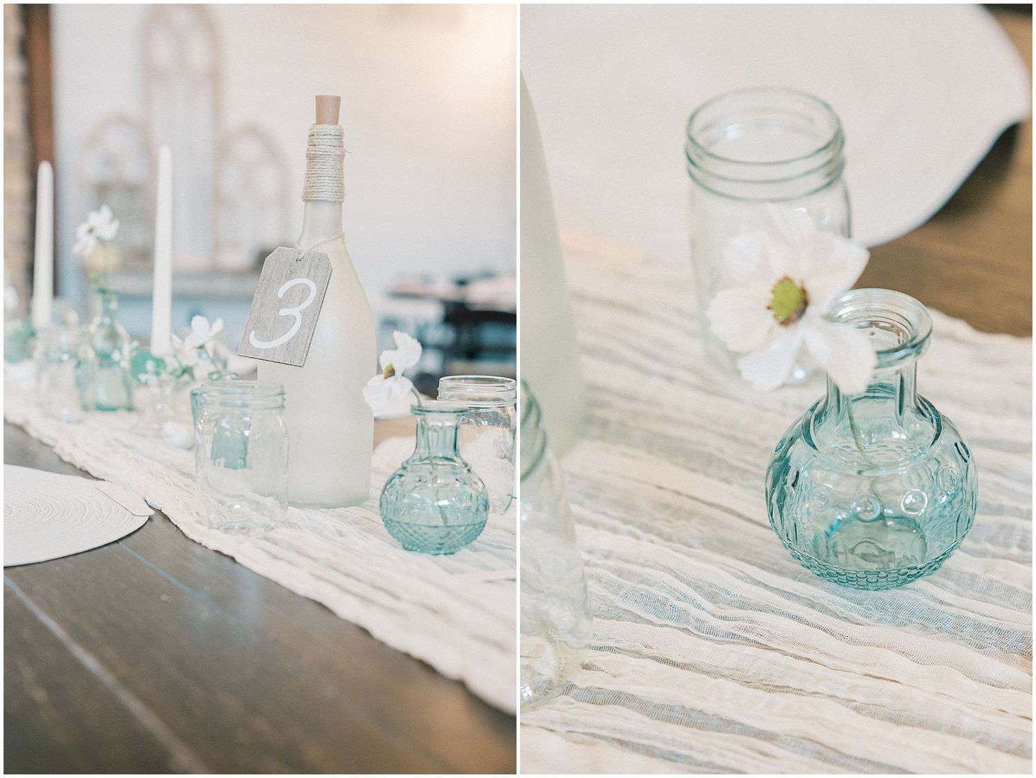 Vintage blue glass mason jars and vases arranged on white linens create an elegant table setting.