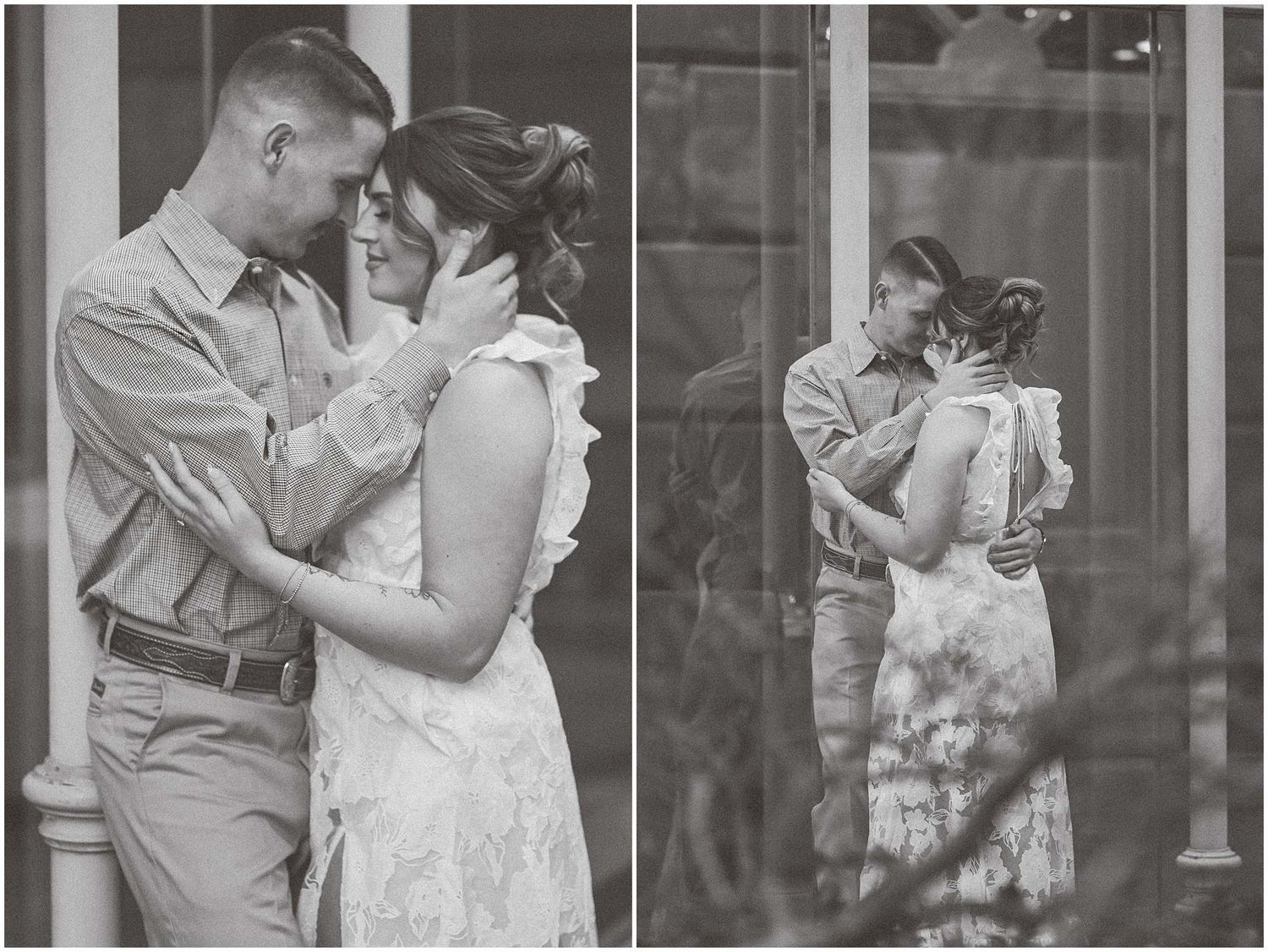 A romantic black and white photo showing a couple embracing in vintage style clothing.