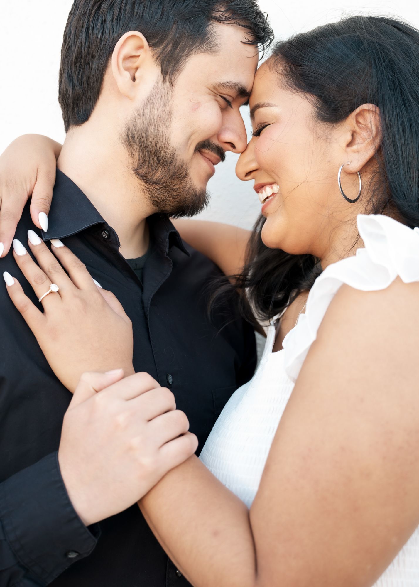 Intimate close-up shots of a couple sharing tender moments against a white backdrop.